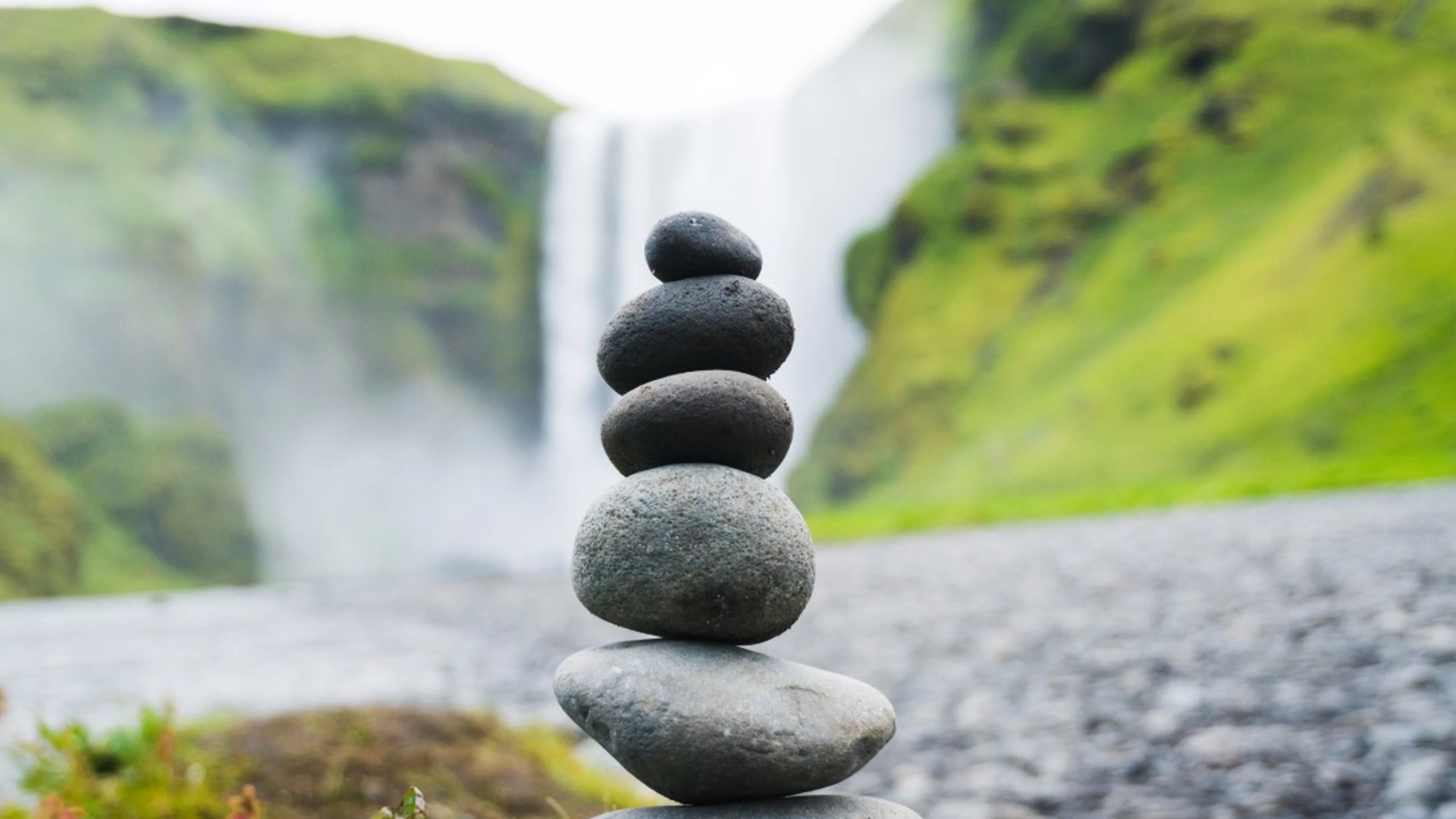 Stack of stones with waterfall in background