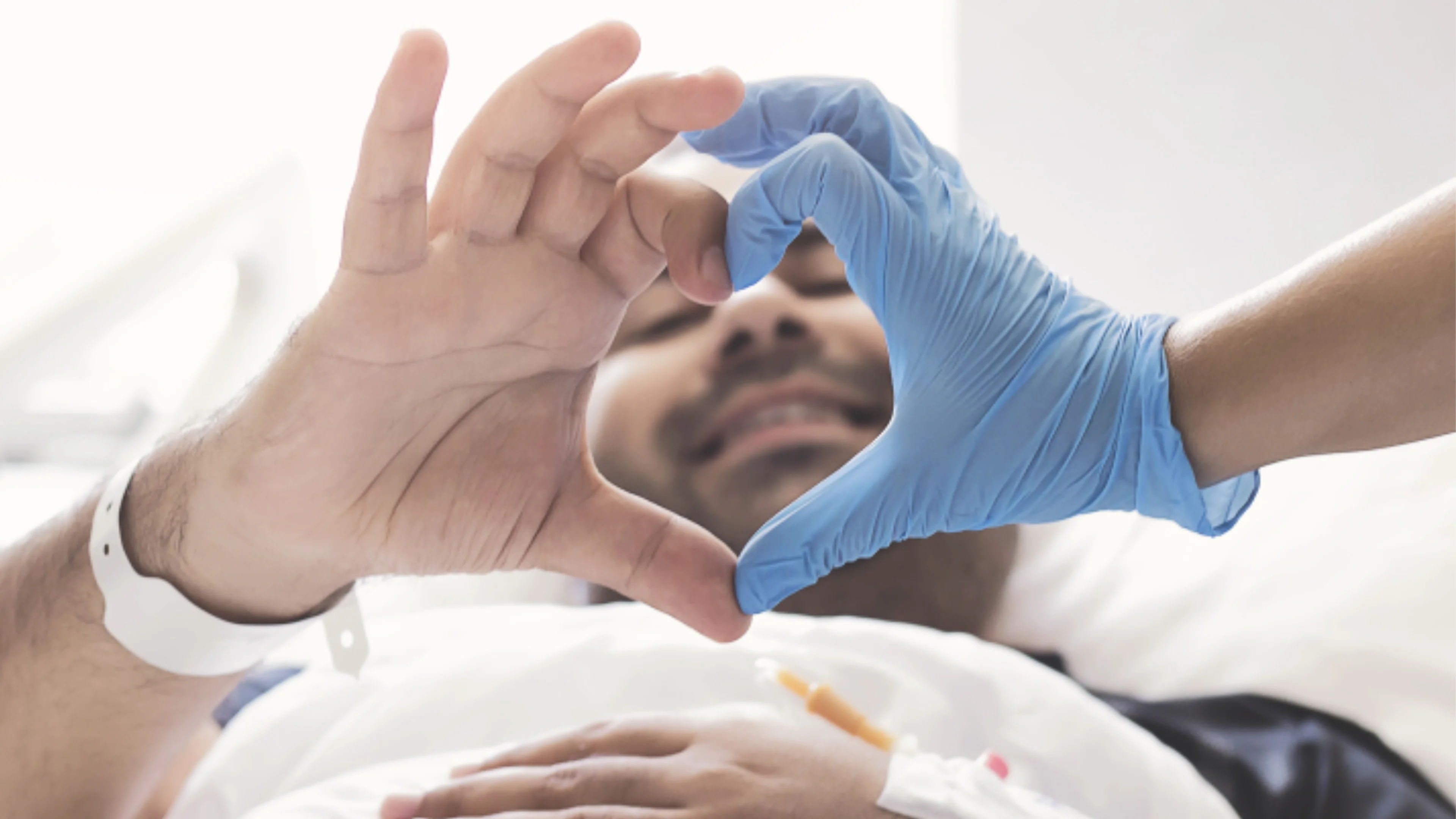 Patient and carer joining hands to create heart