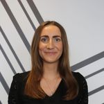 Head and shoulders picture of Lucy Cumberland, in front of a black and white Escape Studios wall mural