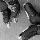 two people wearing skates