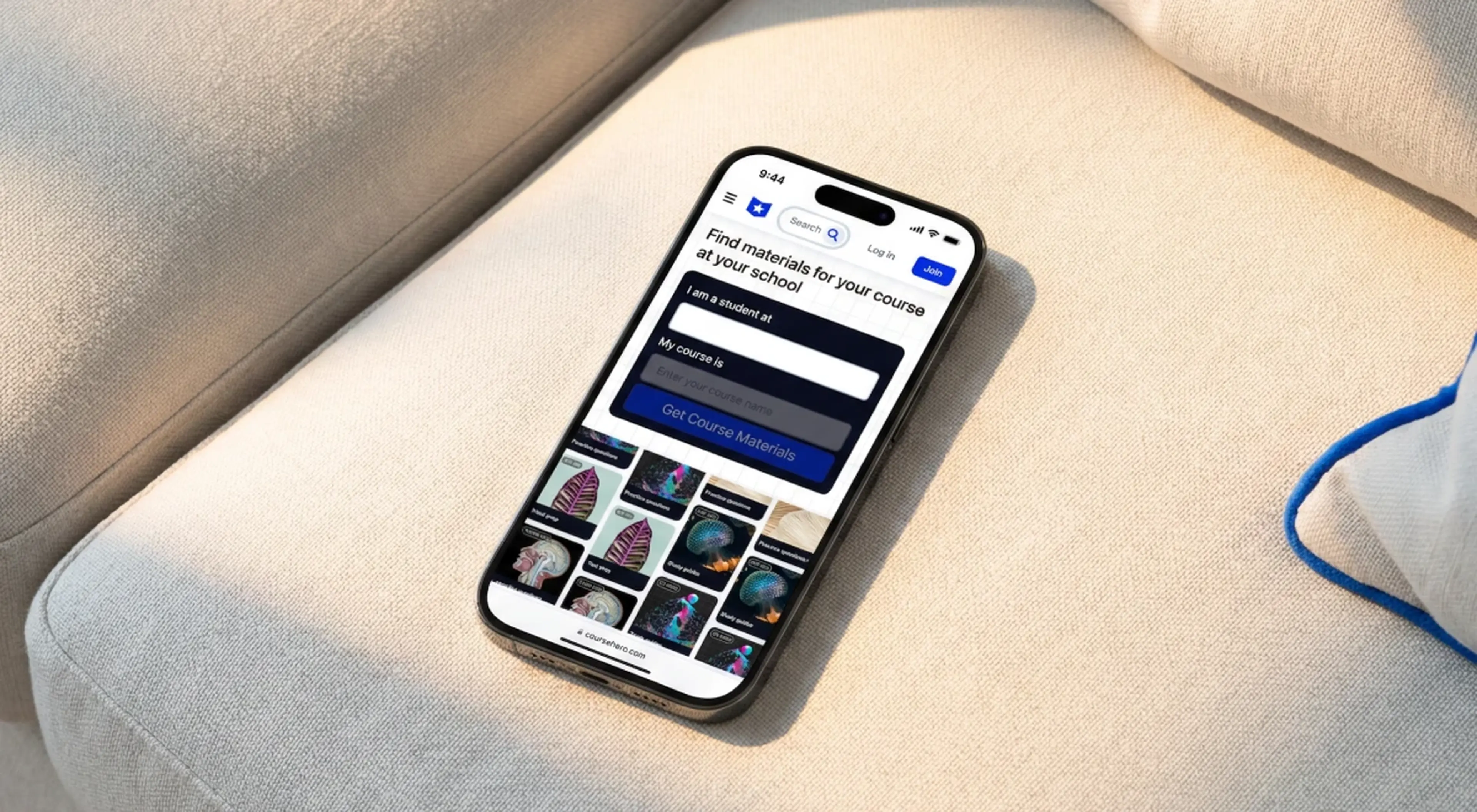 Smartphone lying on a beige fabric sofa displaying the Course Hero app interface for finding course study materials, with a blue rope visible in the background