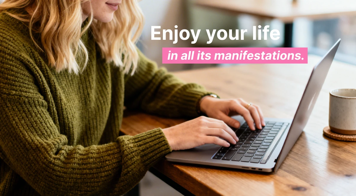 Blonde woman in a green sweater typing on a laptop at a wooden table with a ceramic mug nearby, embracing a growth-oriented life mindset