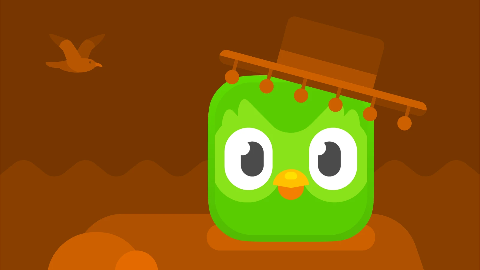 duolingo wearing a Spanish-style hat against a brown background, symbolizing learning spanish