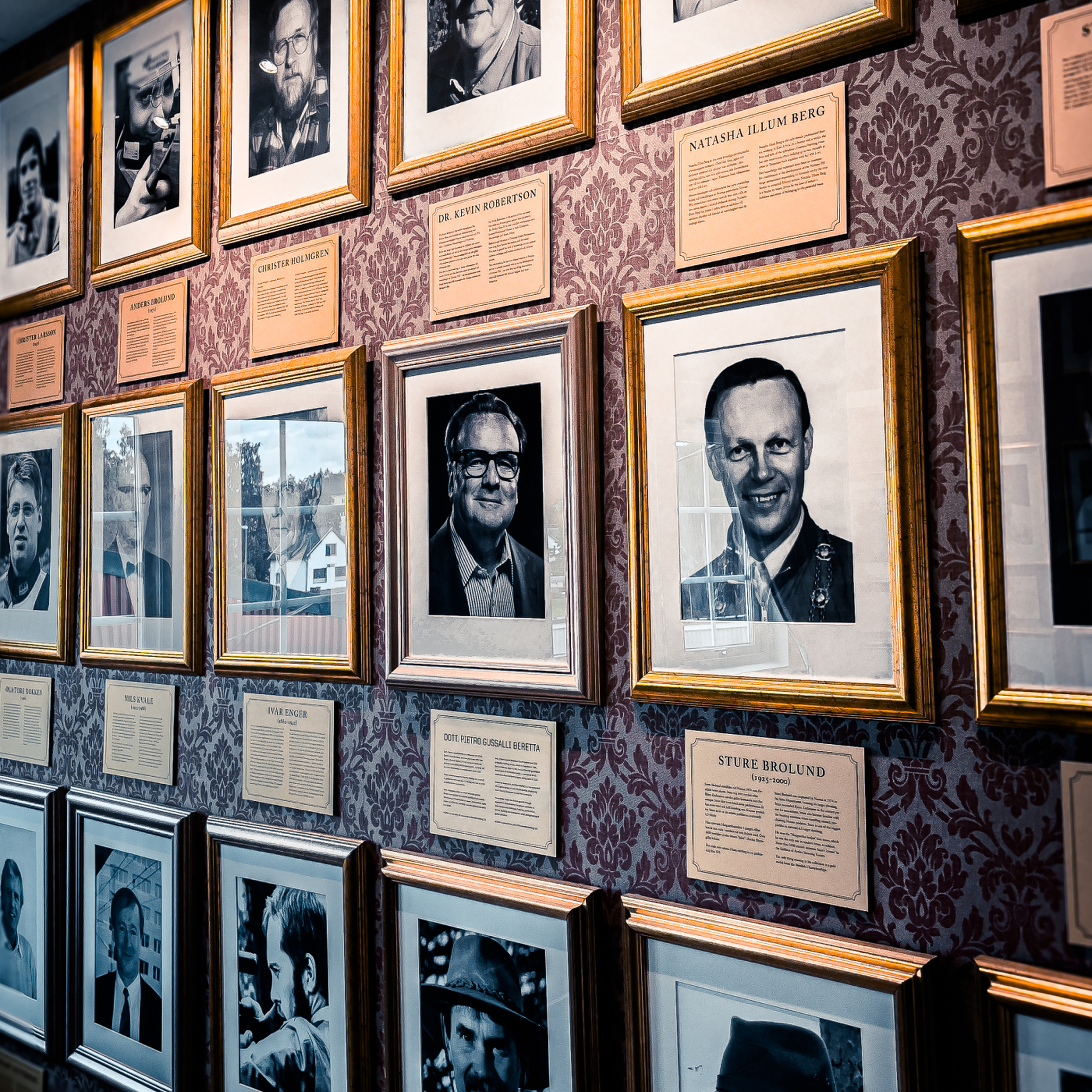 A wall of portraits at Norma, featuring Dr. Pietro Gussalli Beretta