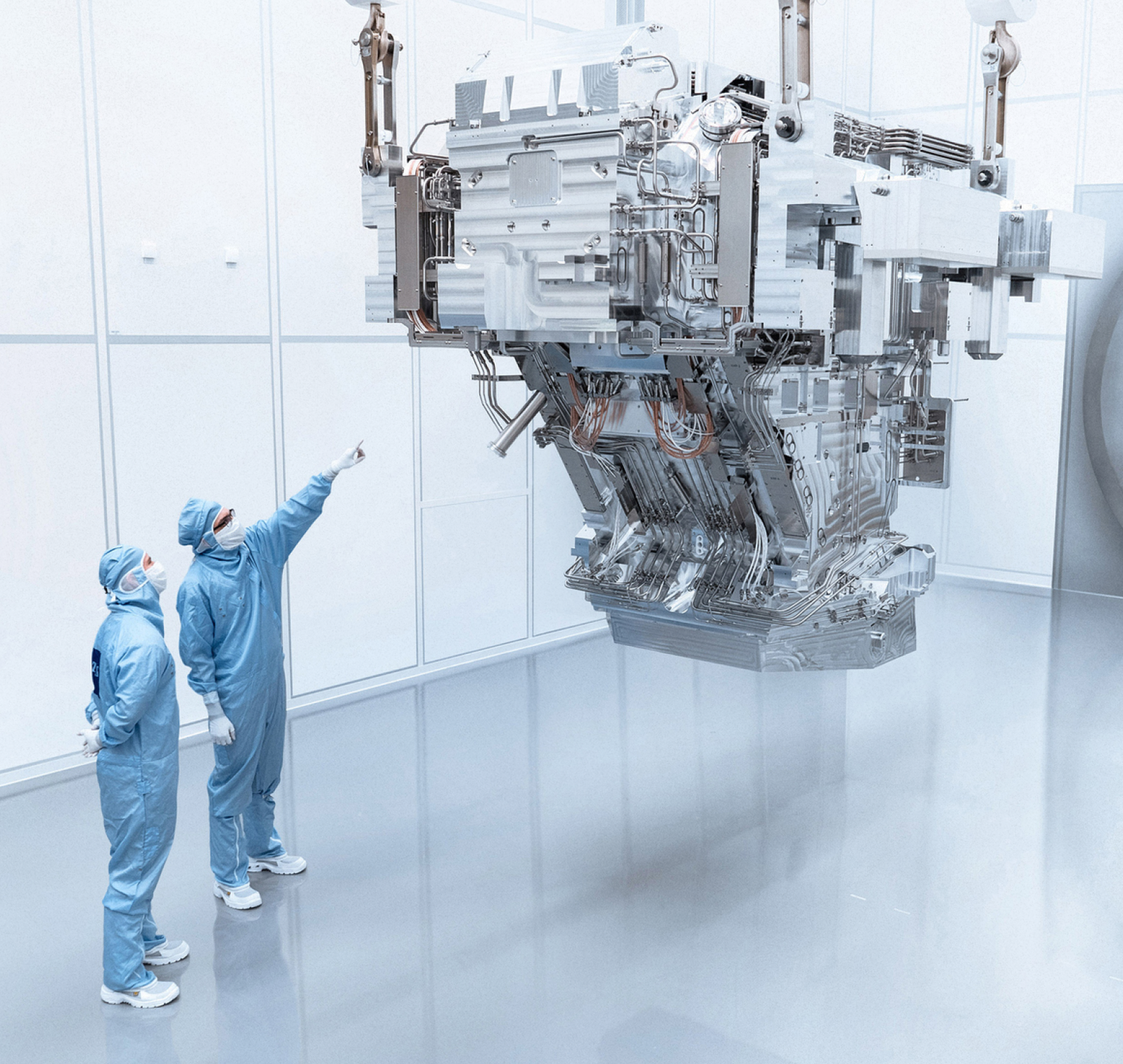 Two Zeiss SMT engineers inspect a new optics system.