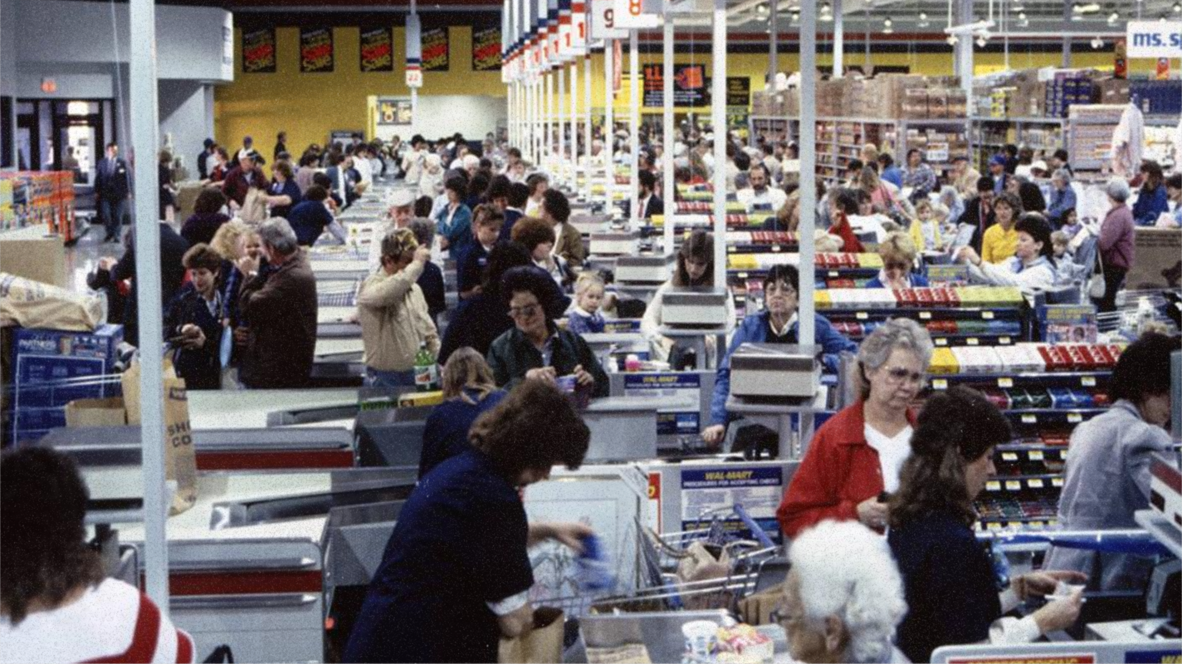 A Walmart cashier station with over a dozen lanes – a scale enabled by the barcode