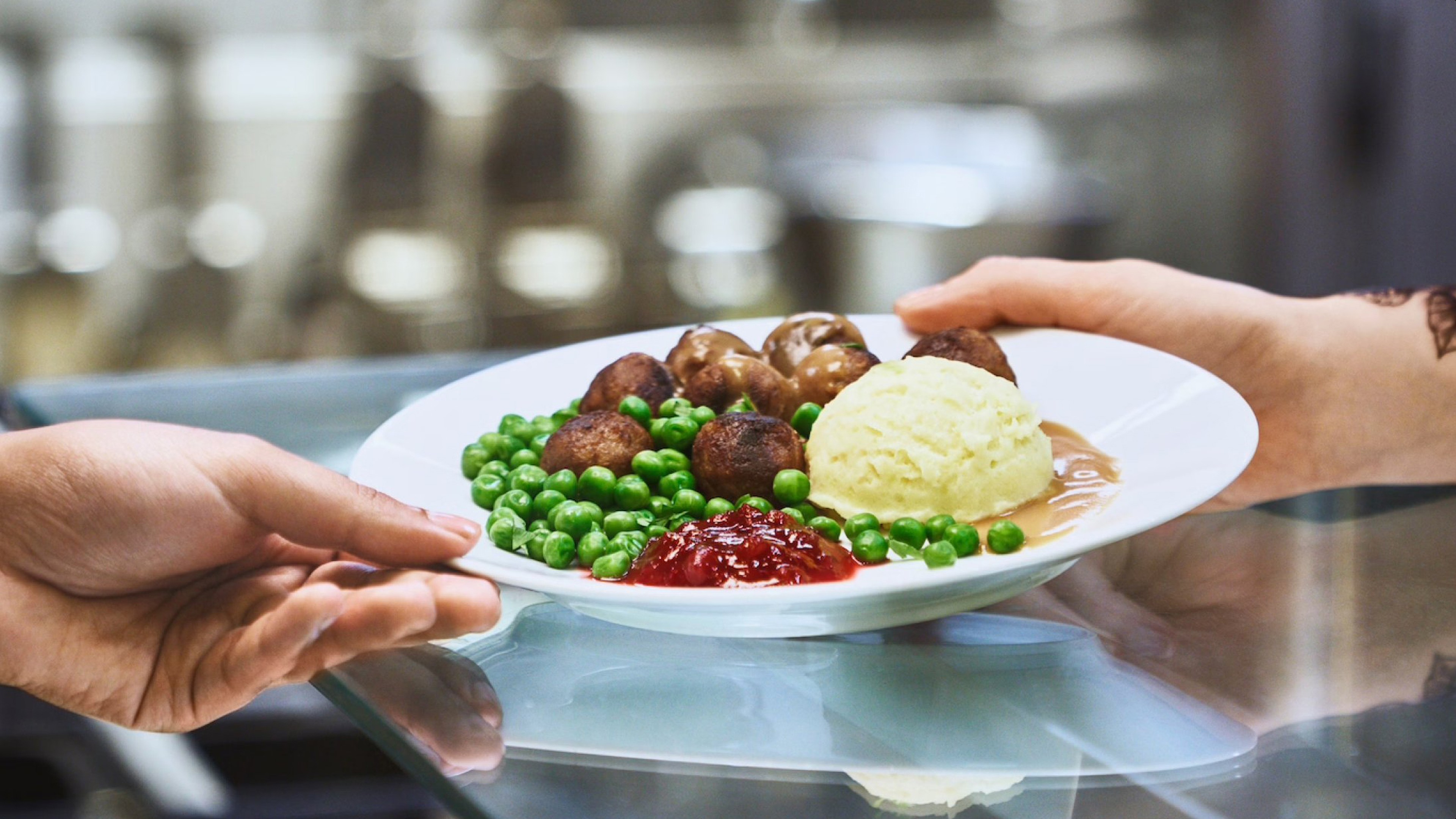 Ikeas meatballs with mashed potatoes, lingonberries, and green pees