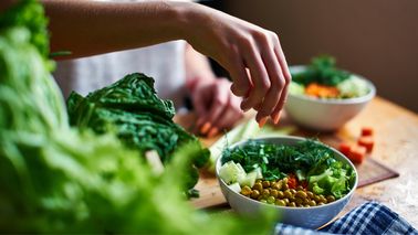Frau bereitet gesundes Essen zu.