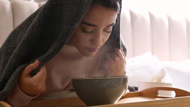 Frau ist krank und inhaliert.