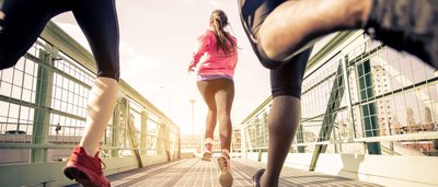 Menschen joggen über eine Brücke in der Stadt