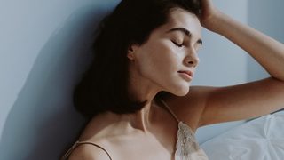 Frau hält sich besorgt den Kopf