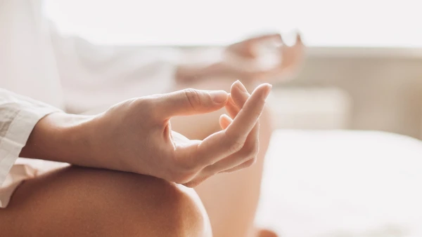 Close-Up von Händen einer Frau die Yoga Nidra macht.