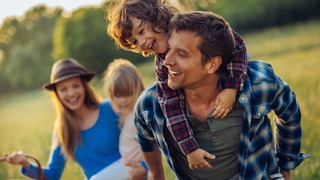 Fröhliche Familie draußen in der Natur