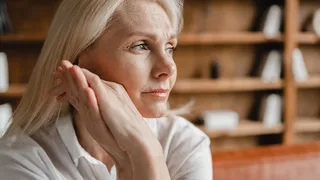Nervöse Frau, die besorgt zur Seite schaut.