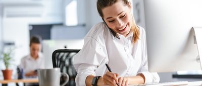 Lächelnde Frau telefoniert in der Kundenberatung