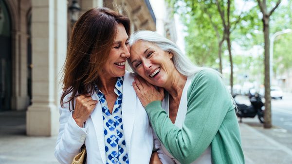 Zwei ältere Frauen gehen in der Stadt spazieren.