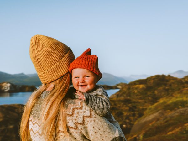 Mutter trägt ihr Kind auf dem Arm