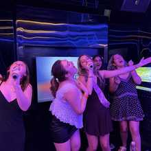 Guests singing karaoke on a busy bar night