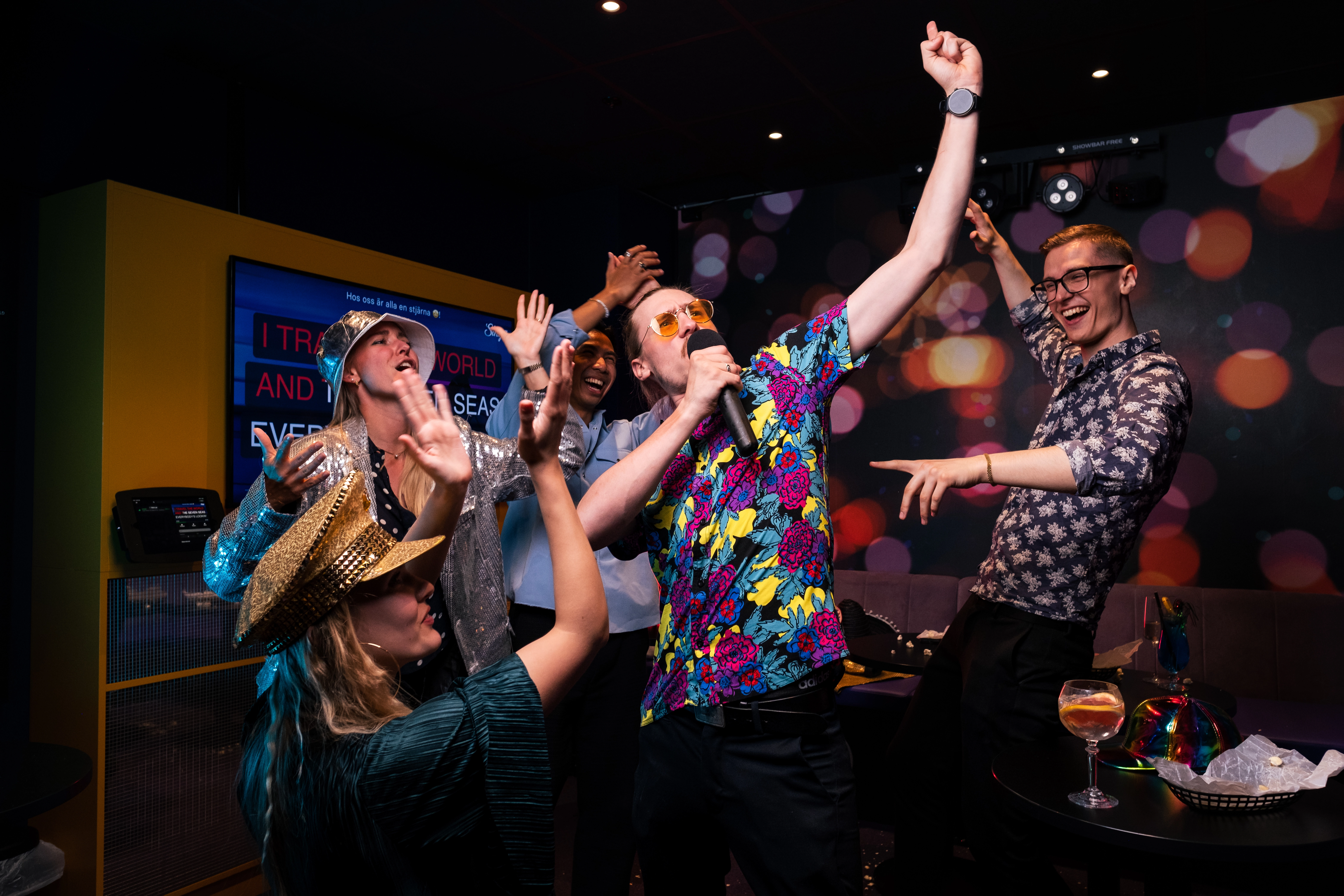 Group of people partying in karaoke room
