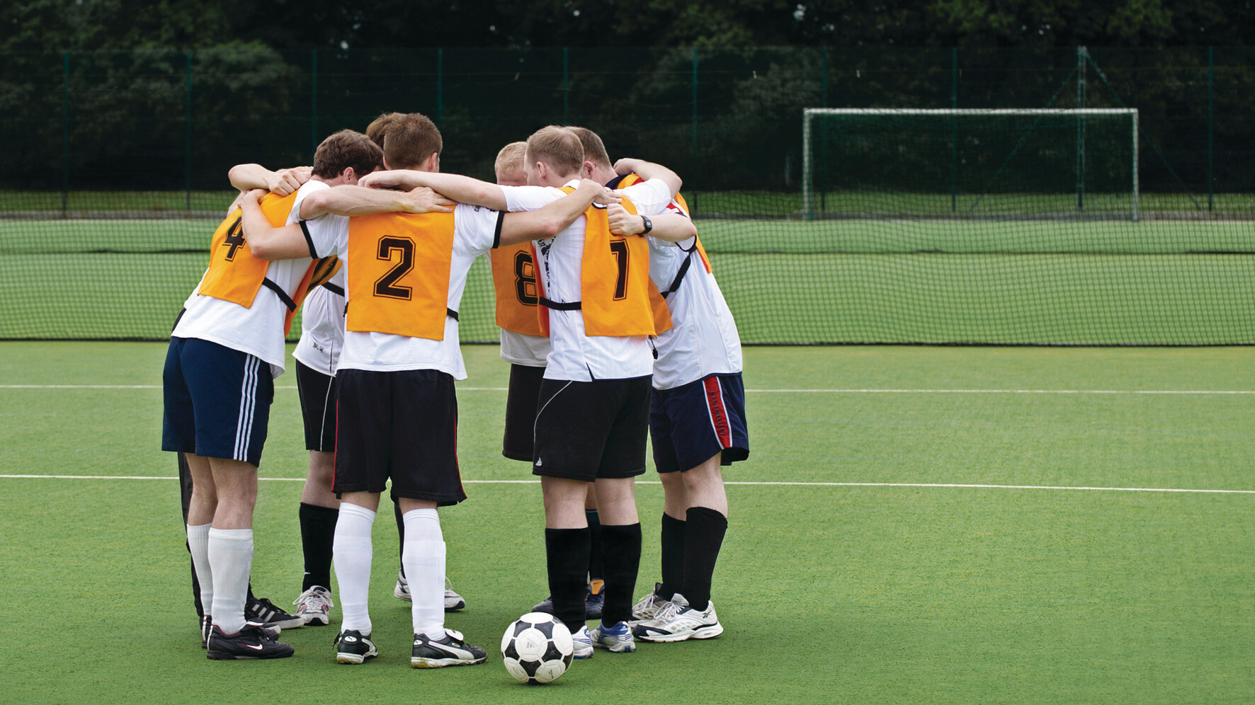 UEA football players in a huddle