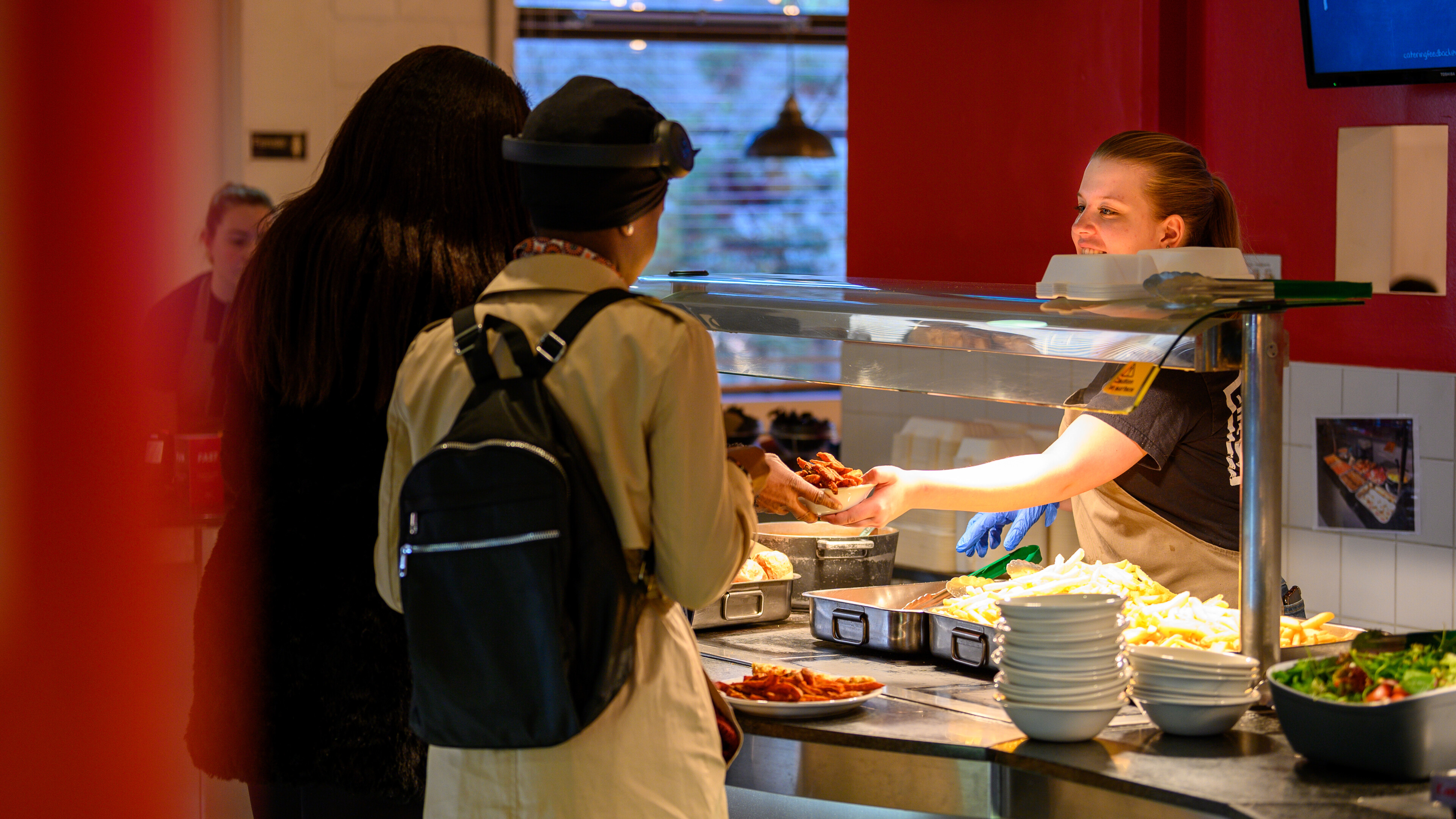 Students being served food at Zest