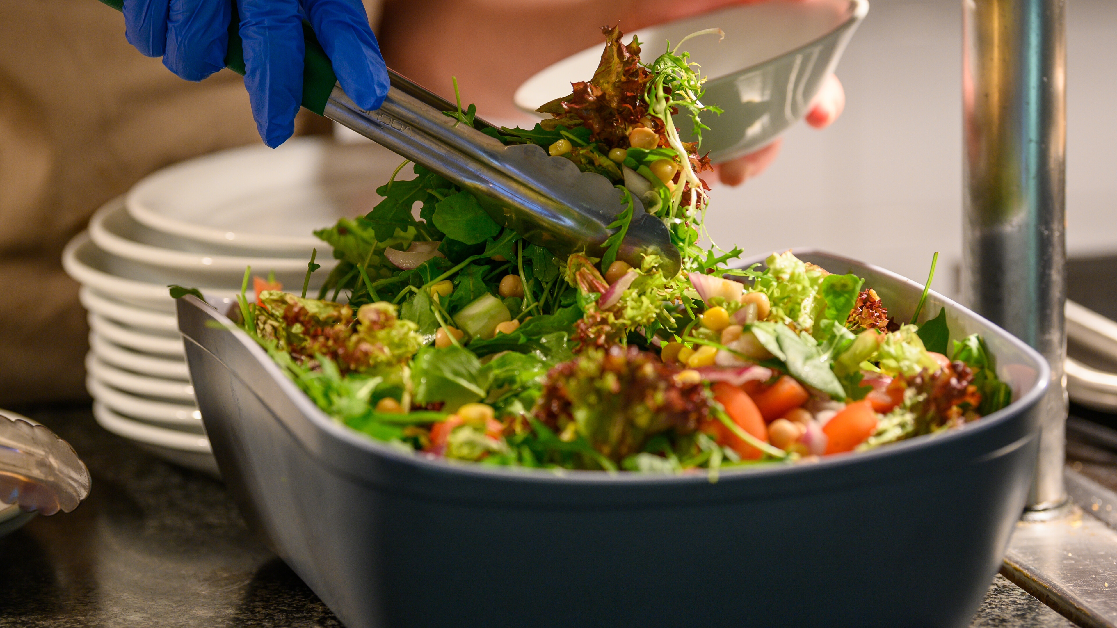 Salad being served by staff.