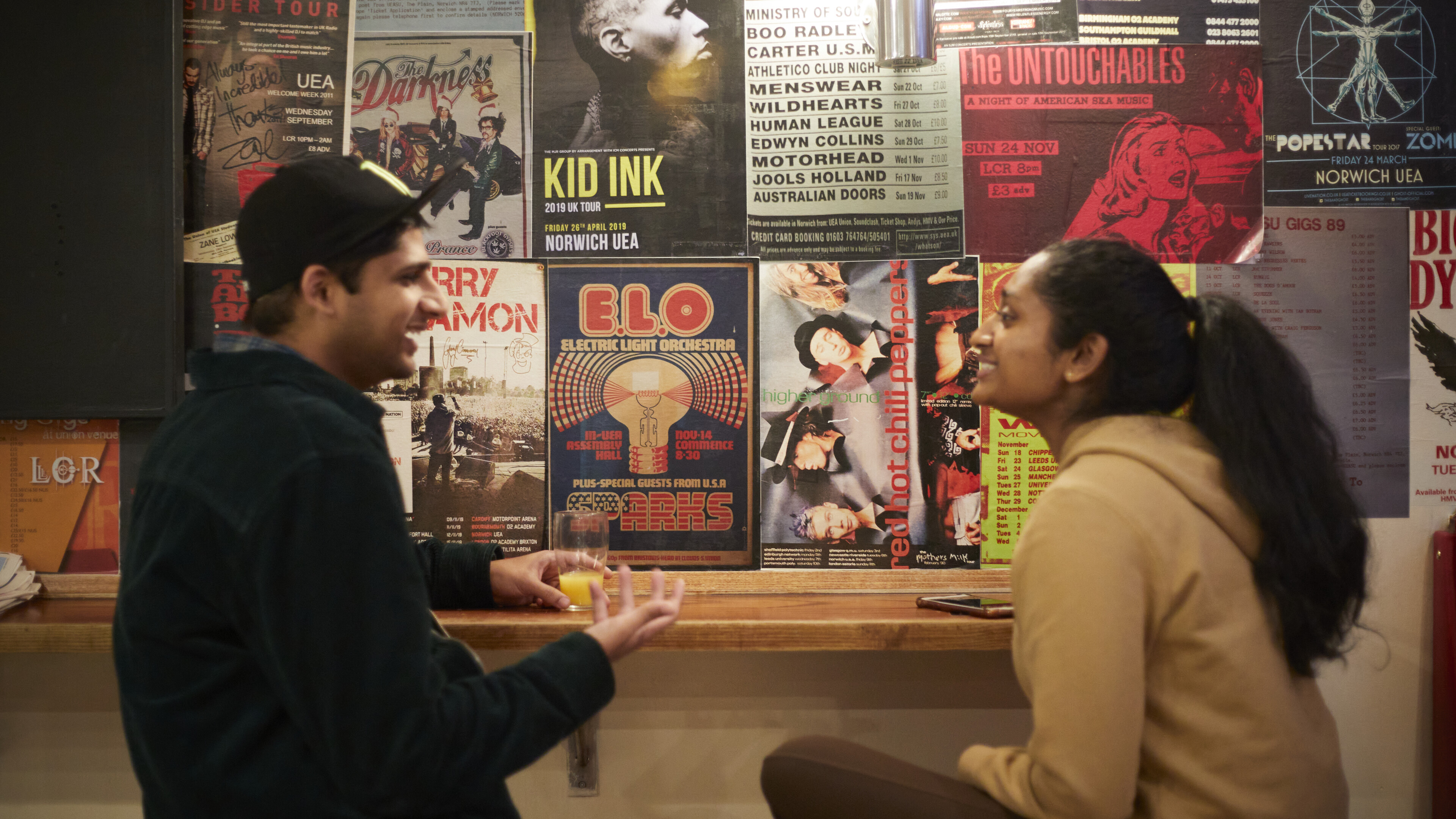 Two people having a conversation at the SU bar.