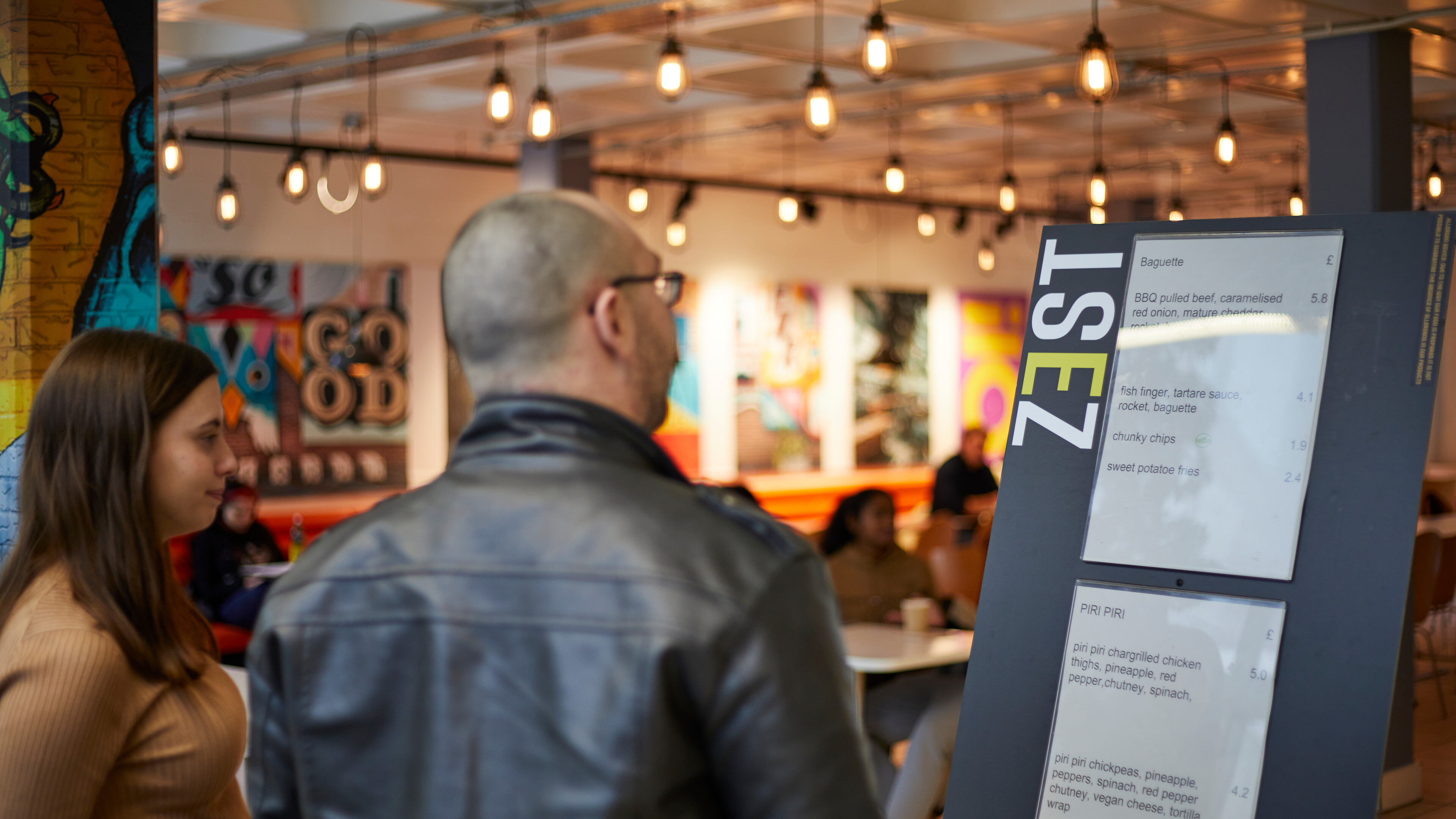 Students looking at Zest menu