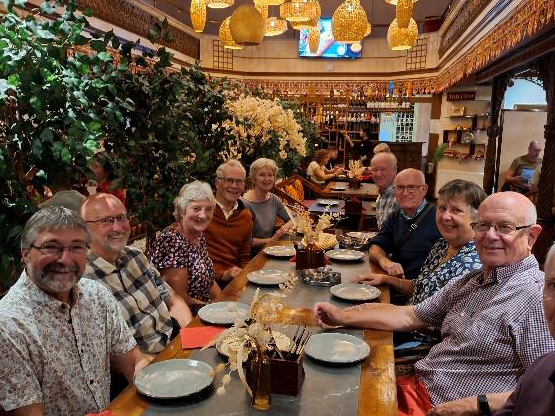 UEA Graduates sitting around restaurant table