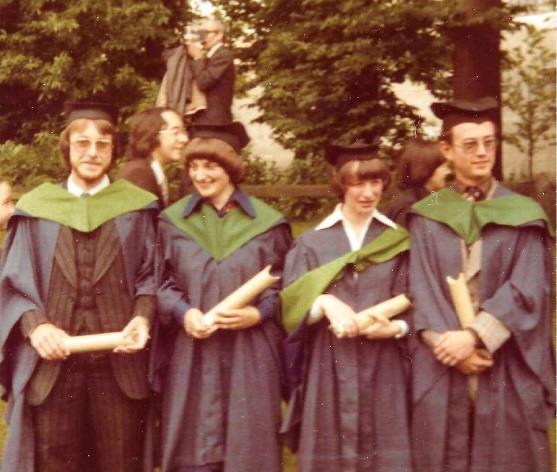 4 UEA Graduates in graduation gowns