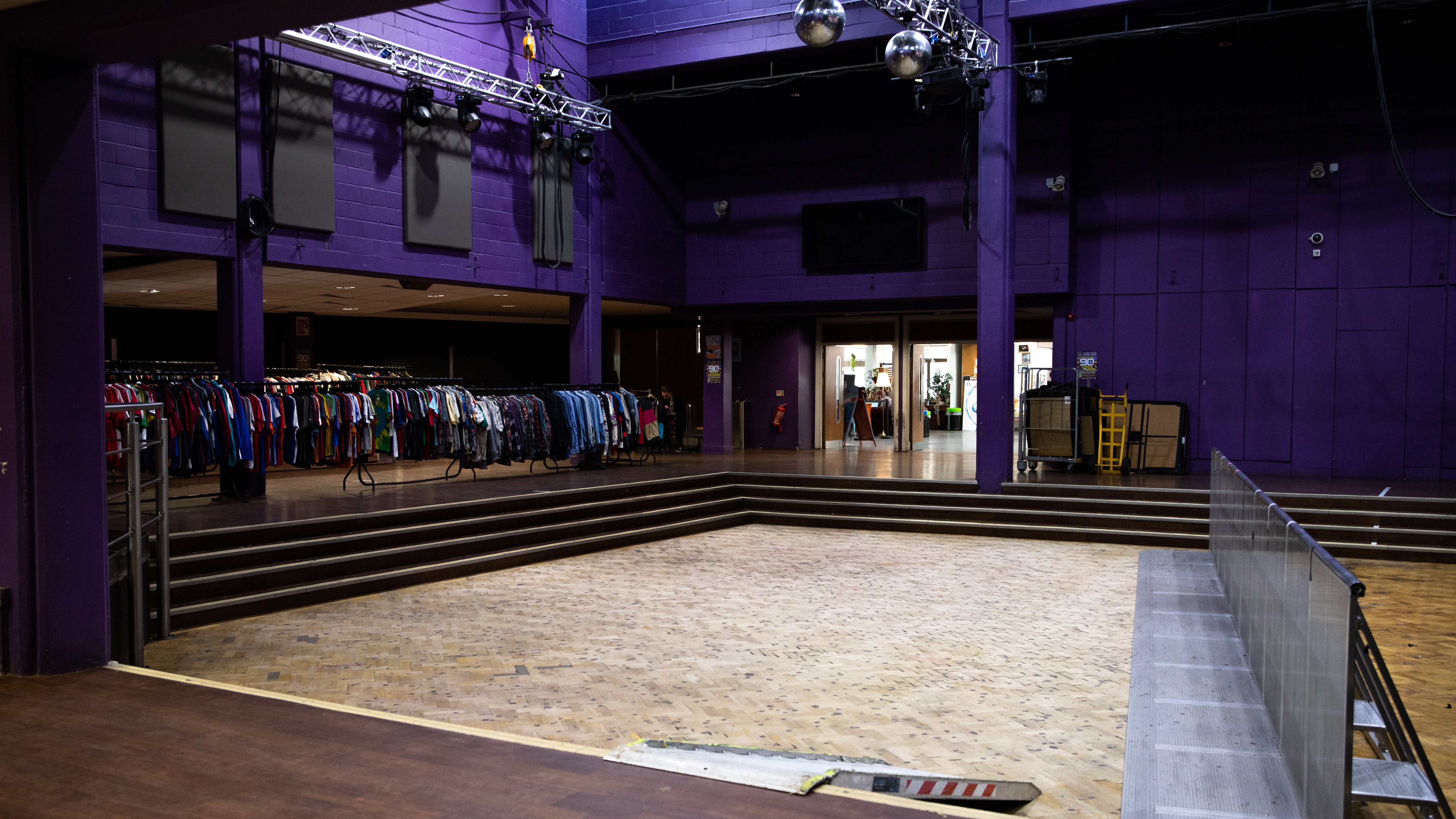 The LCR space empty aside from clothes racks set up to the left of the room.