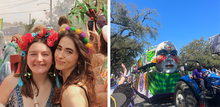 Two women smiling at a colorful outdoor festival; a parade float with a large mask and vibrant decorations in the background