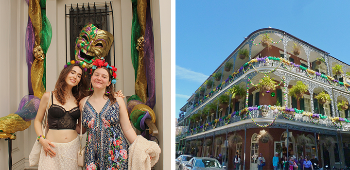 Two women smiling in front of a colorful Mardi Gras display; a festive, decorated building under a clear blue sky