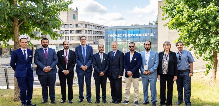 Representatives from UEA and Majmaah University stand in front of The Square at UEA campus.