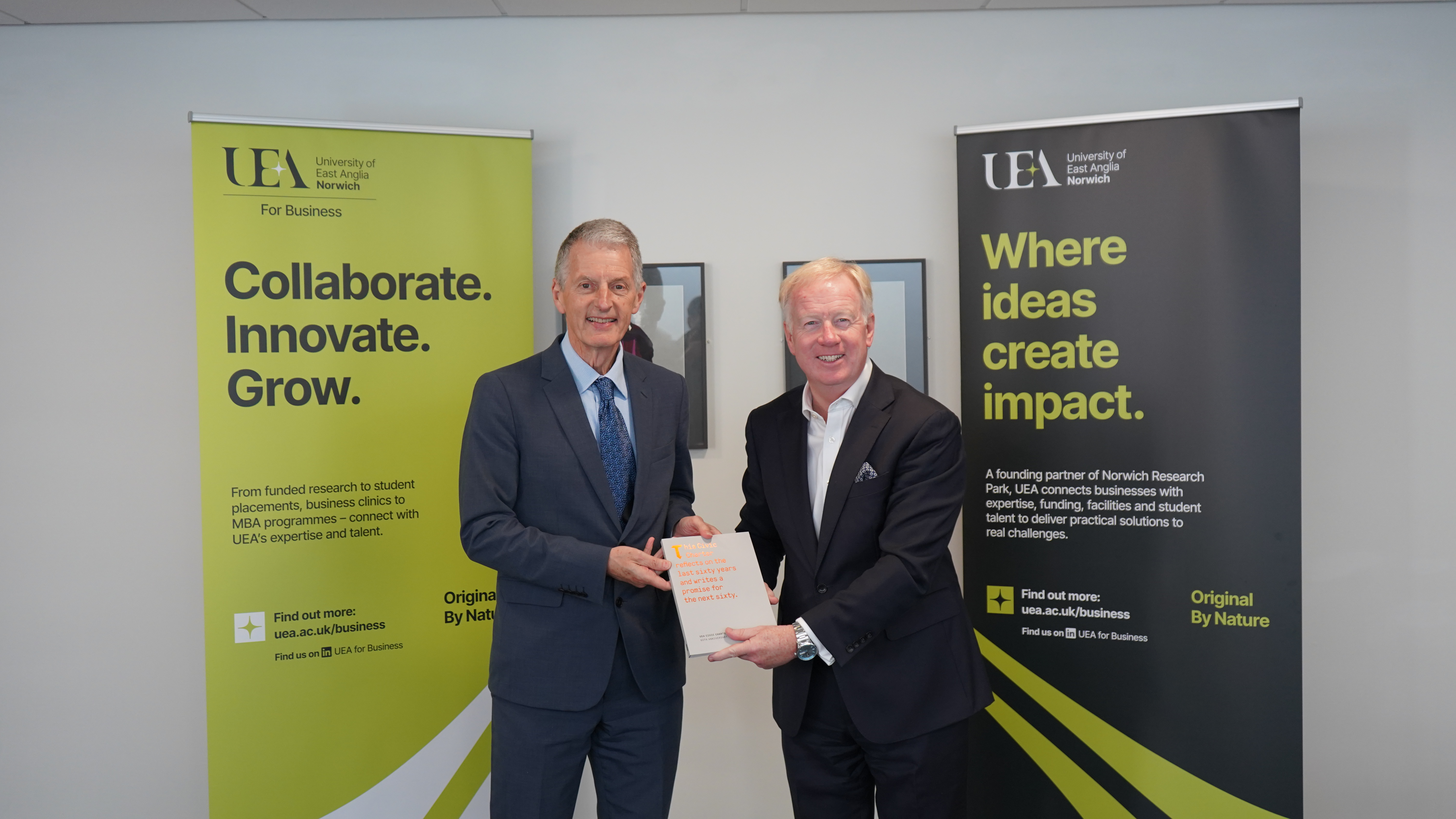 UEA Vice Chancellor, Prof David Maguire, with Anglian Water CEO, Mark Thurston, holding a copy of UEA's Civic Charter