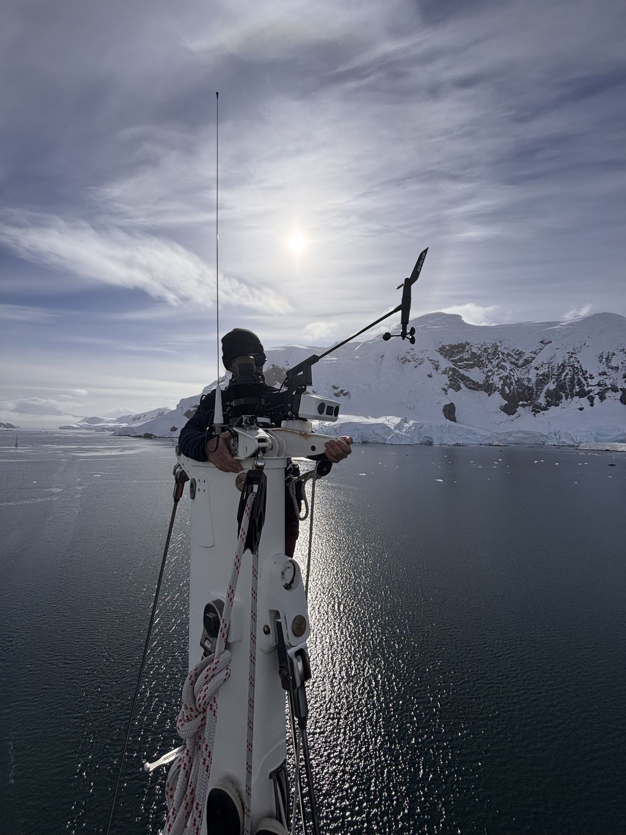 Jonathan Morice on the mast of Malizia Explorer checking the rigging and SEA.AI watchkeeper.