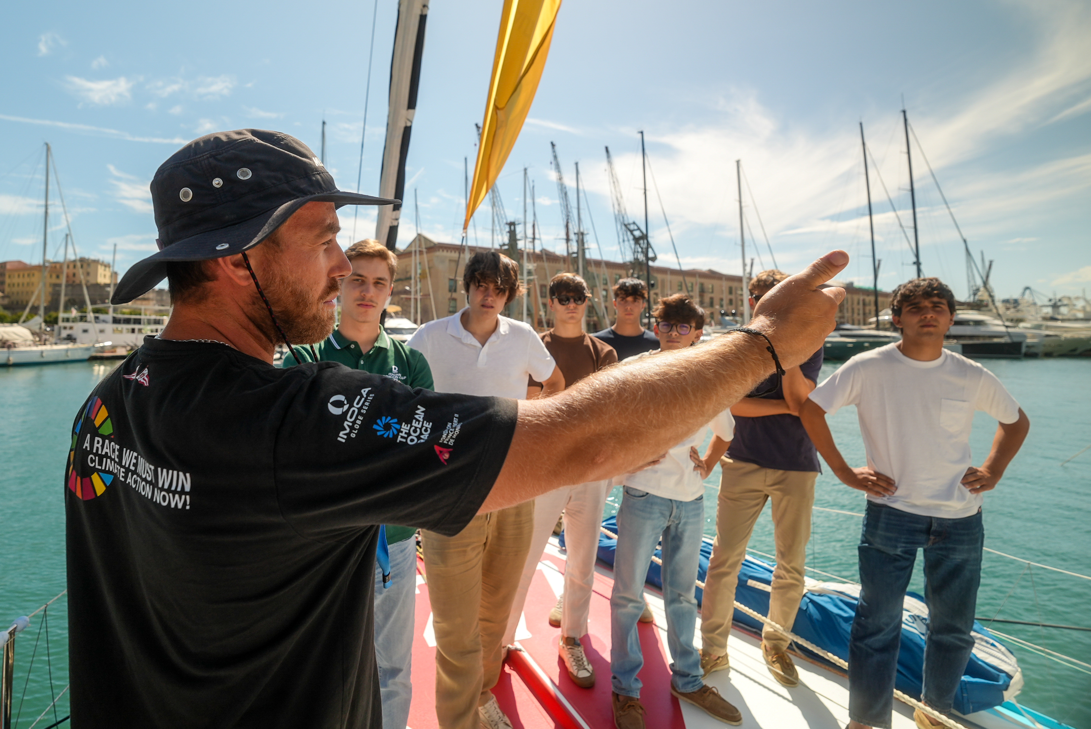 Students from the International School of Genova join for a tour of the Malizia - Seaexplorer racing yacht.
