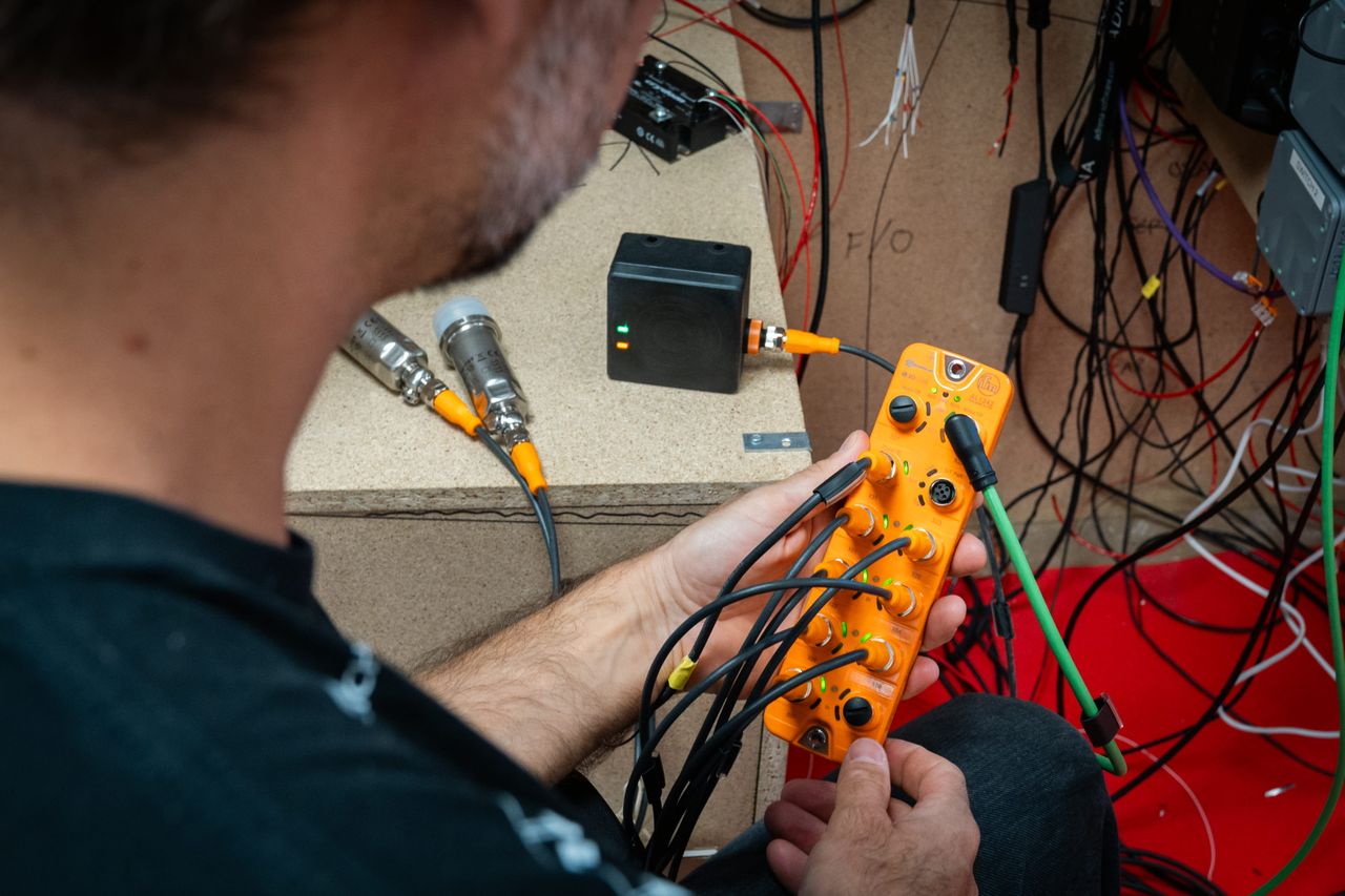 Boris Herrmann with an ifm sensor during the new build of Team Malizia's next IMOCA