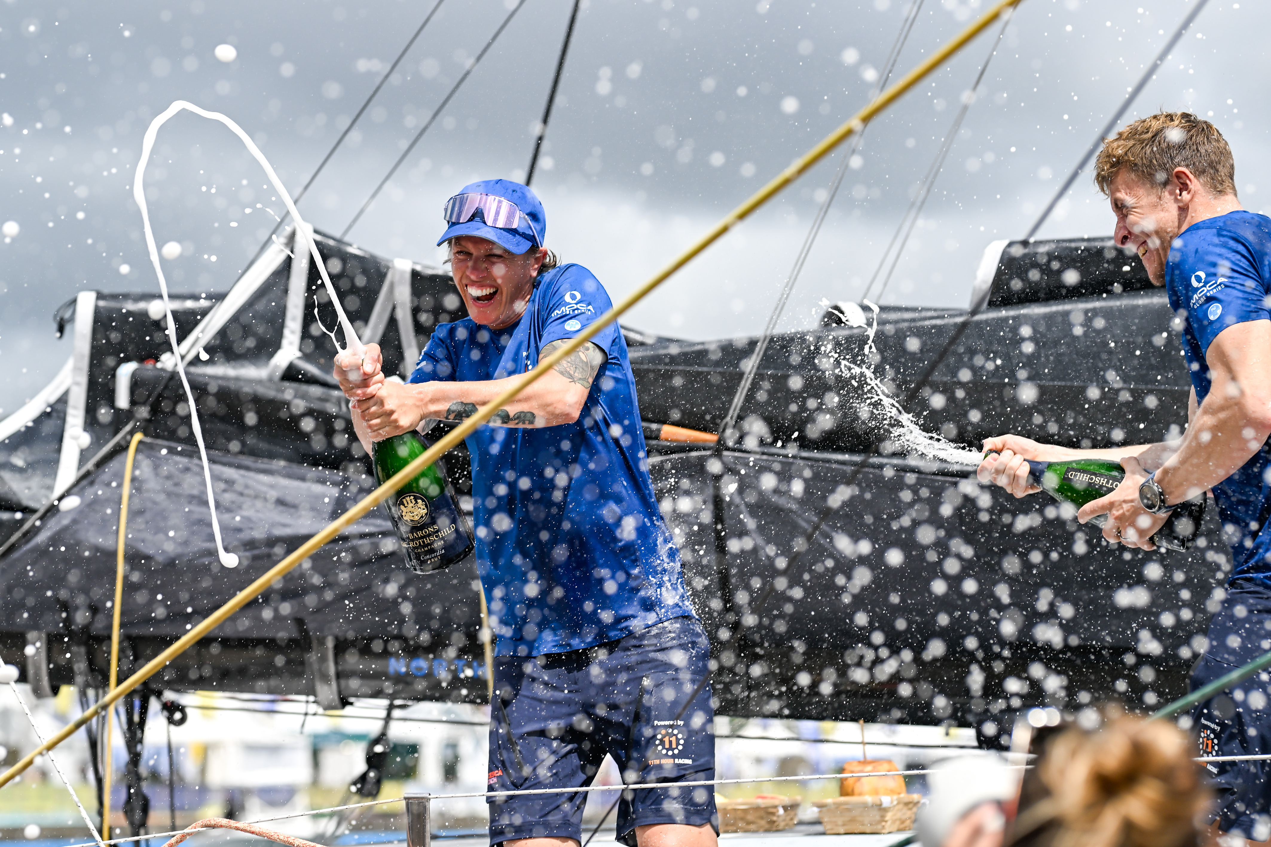 FORT-DE-FRANCE, MARTINIQUE : IMOCA 11th Hour Racing, skippers Francesca Clapcich and Will Harris celebrate after taking second place in their category of the Transat Café l'OR 2025 on November 7, 2025 in Fort-de-France, Martinique