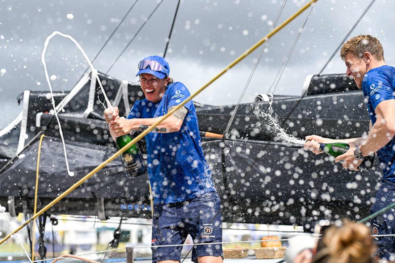 FORT-DE-FRANCE, MARTINIQUE : IMOCA 11th Hour Racing, skippers Francesca Clapcich and Will Harris celebrate after taking second place in their category of the Transat Café l'OR 2025 on November 7, 2025 in Fort-de-France, Martinique