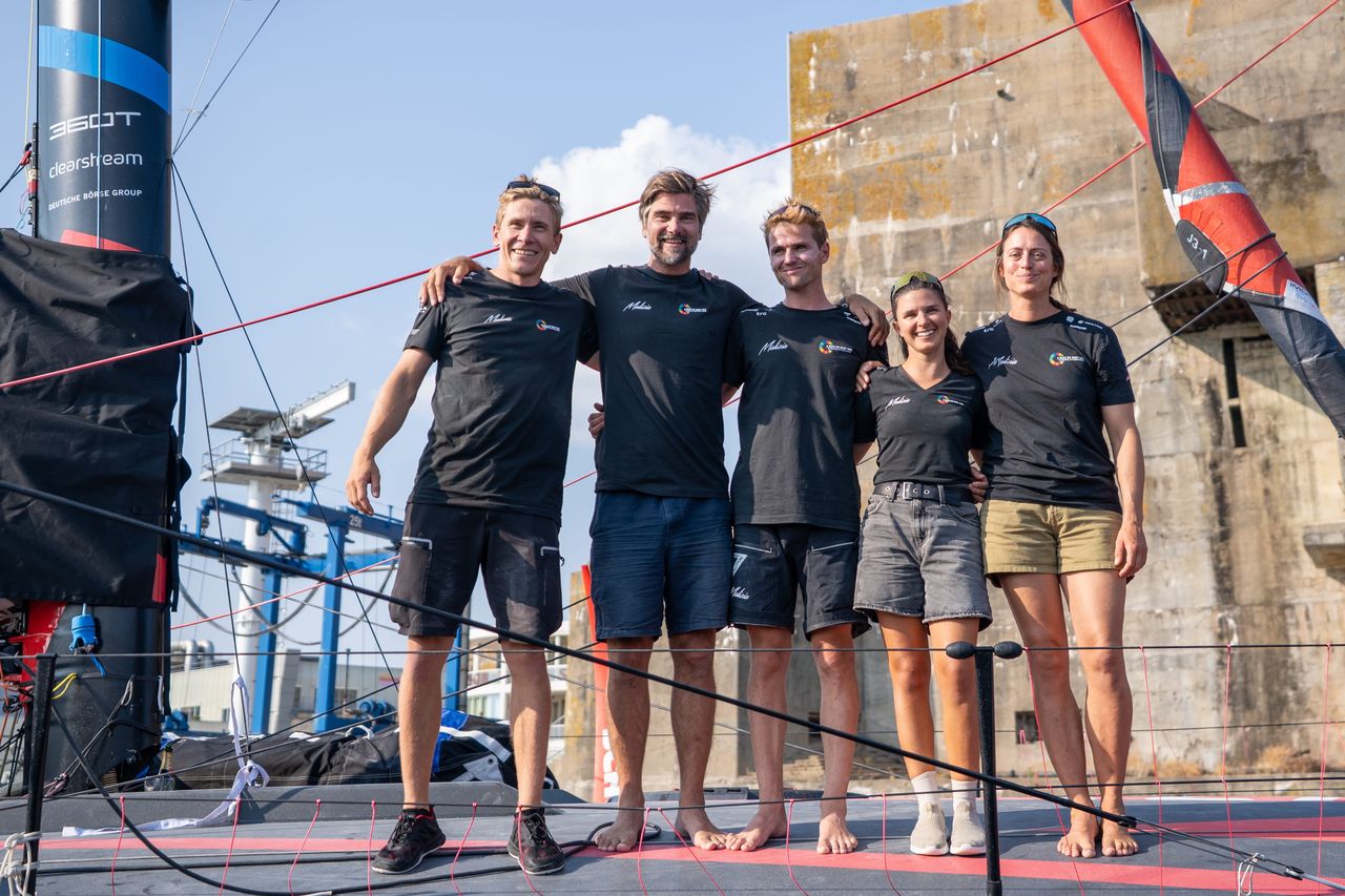 Team Malizia sailors Will Harris, Boris Herrmann, Loïs Berrehar, Cole Brauer and Justine Mettraux moments before the christening of Malizia 4