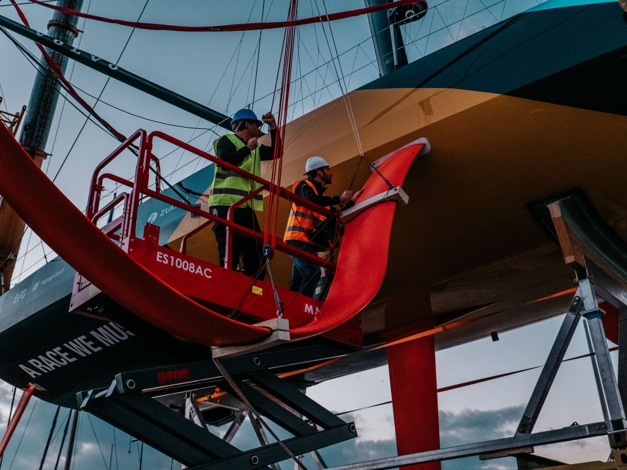 Moment of truth: The new foils being fitted only days before the start of the race.