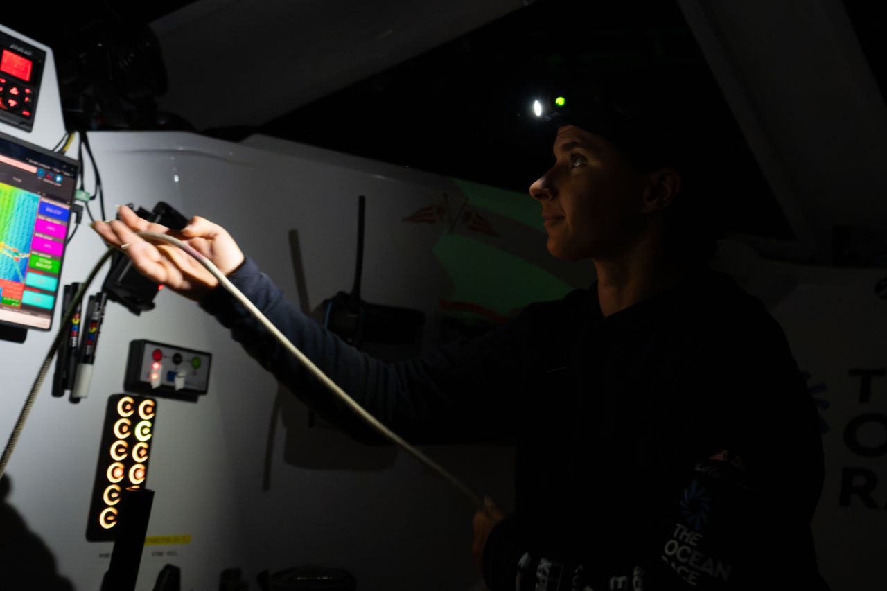 Cole Brauer sailing at night onboard Malizia 4
