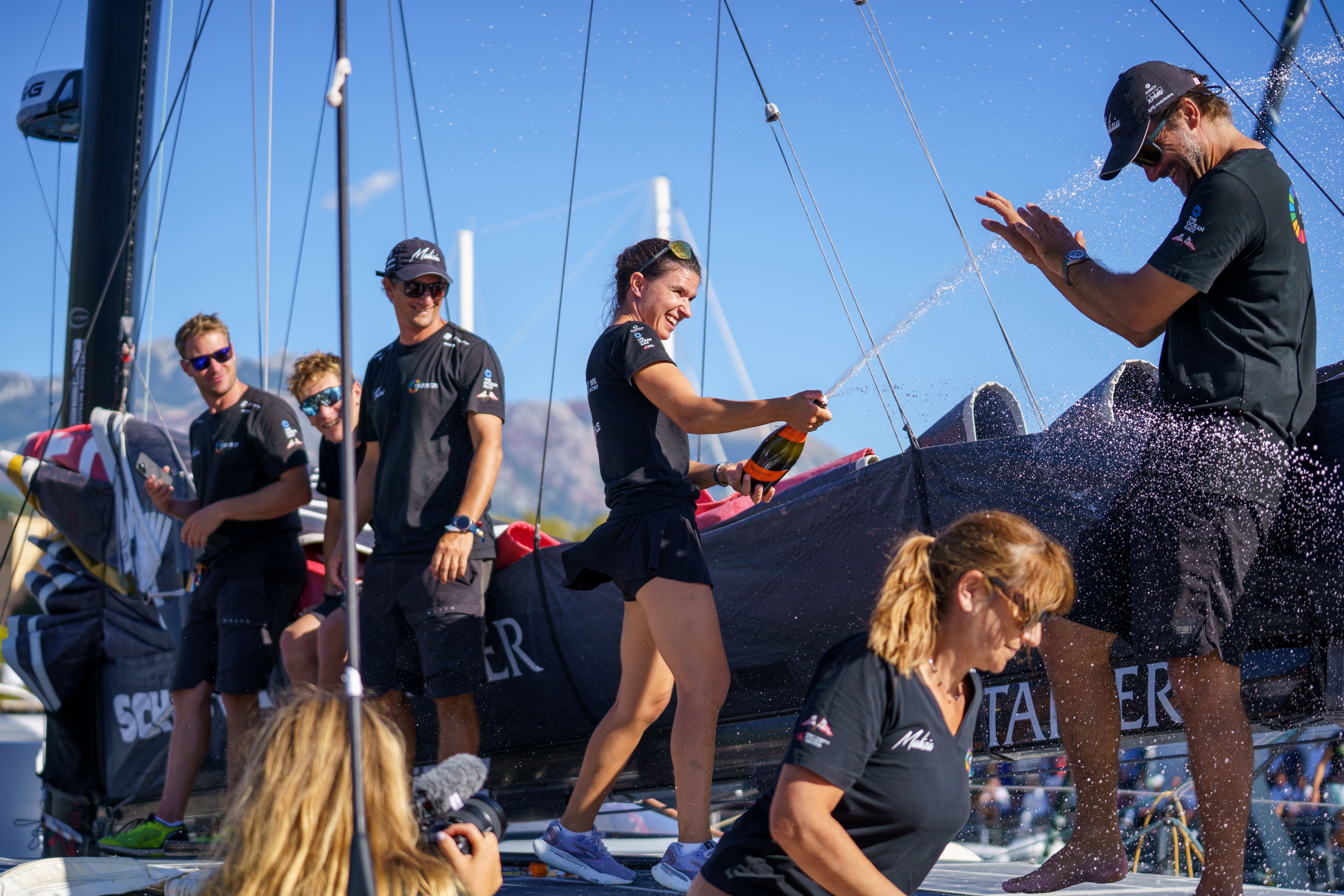 Team Malizia celebrating their fourth-place finish