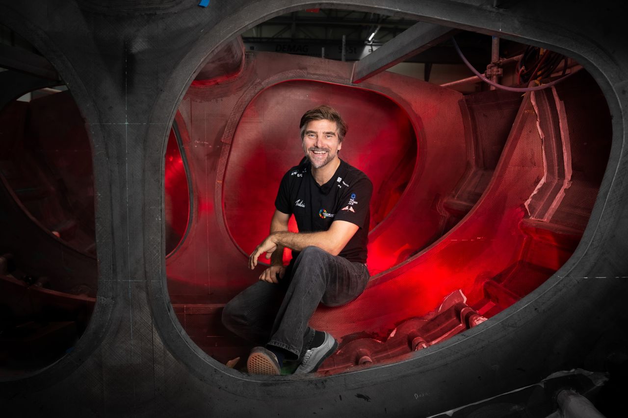 Boris Herrmann sitting in the sail locker of Team Malizia's next IMOCA which is currently being built in Lorient
