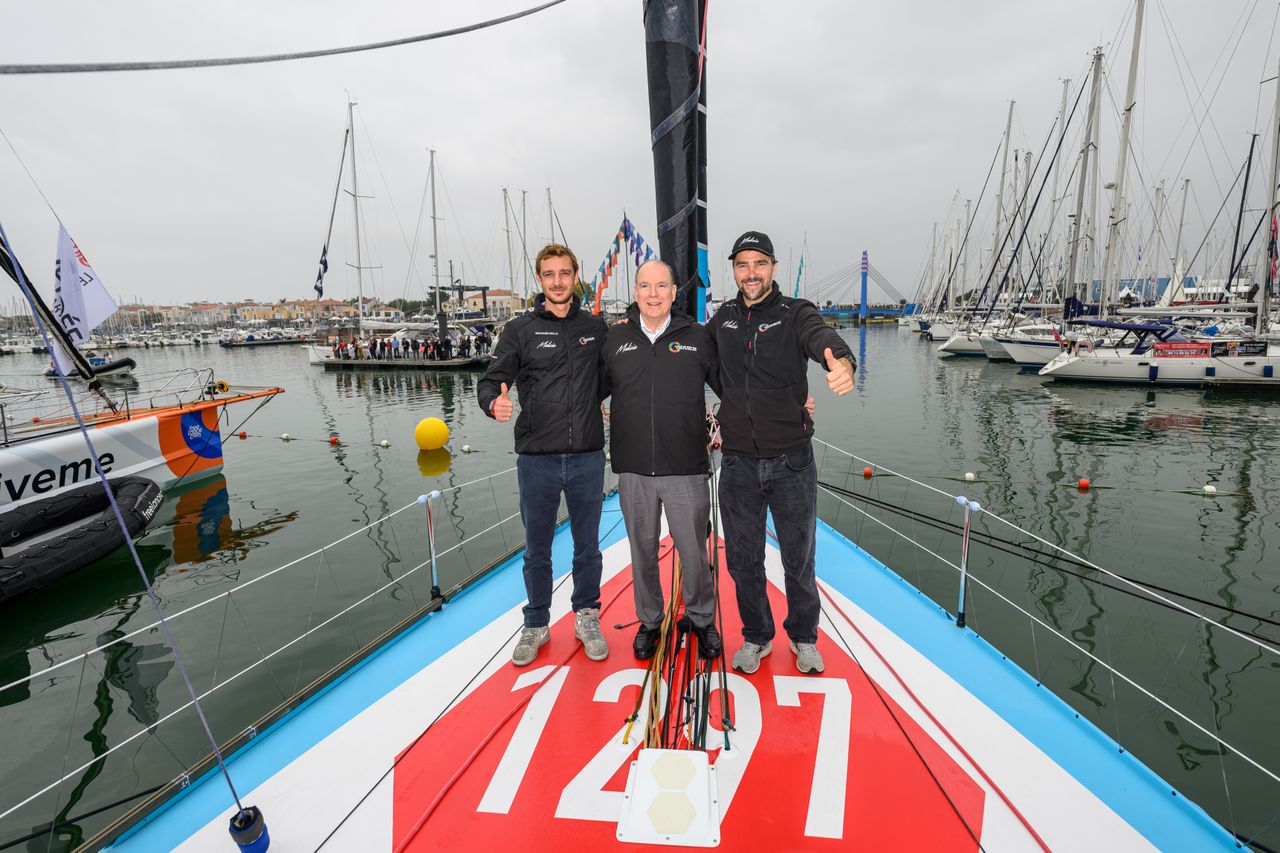 Pierre Casiraghi, His Highness Prince Albert II, and Boris Herrmann onboard Malizia - Seaexplorer next to her number 1297 which refers to the year Monaco was founded