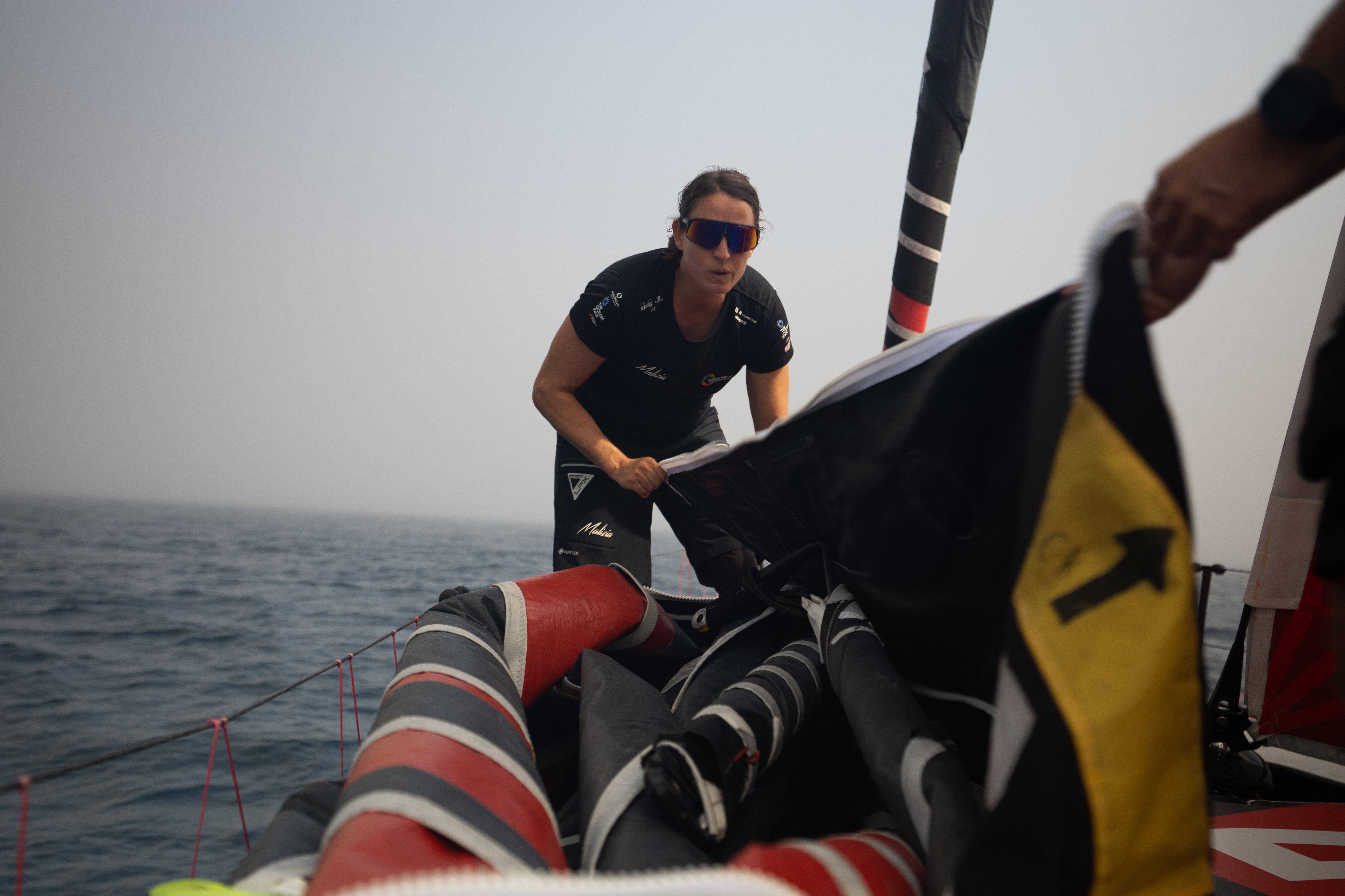 Justine Mettraux onboard Malizia 4 doing a sail change