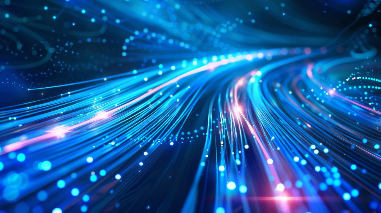 Abstract image of glowing blue and pink fiber optic cables, depicting a dynamic flow of light and data in a digital network.