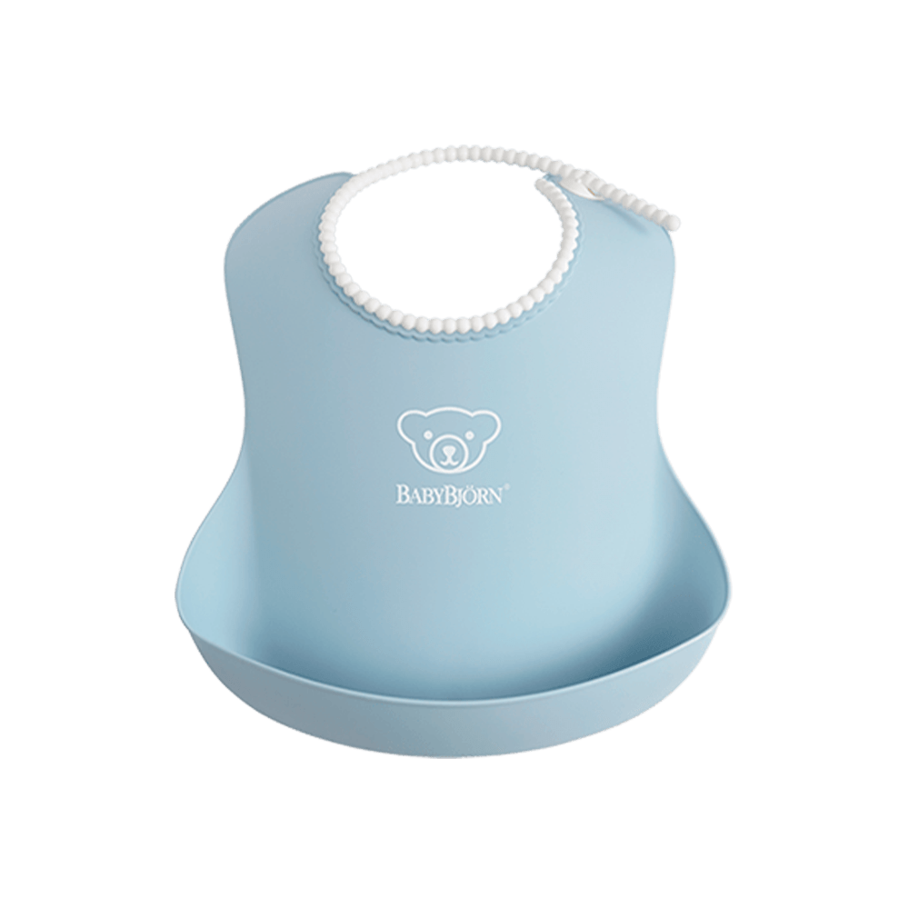 Light blue BabyBjörn bib with a bear logo, featuring a rounded neck and a deep spill pocket at the bottom.
