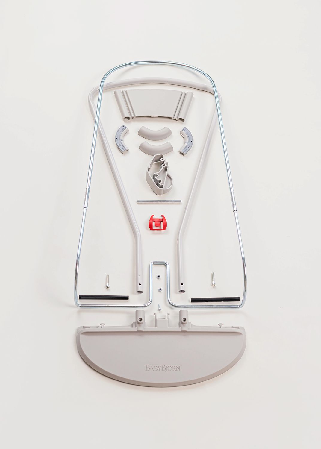 Metal frame and components of a disassembled baby bouncer laid out on a white background.